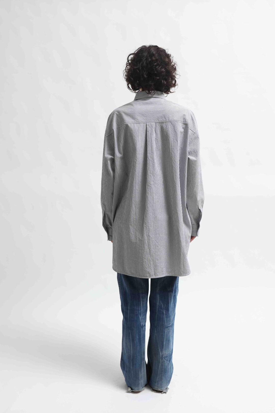 Crisp 100% organic cotton shirt with classic collar and marine blue and white stripes, handcrafted by House of Woven Stories in Italy’s Piedmont region, featuring a soft paper-touch finish and relaxed fit for versatile, refined style.