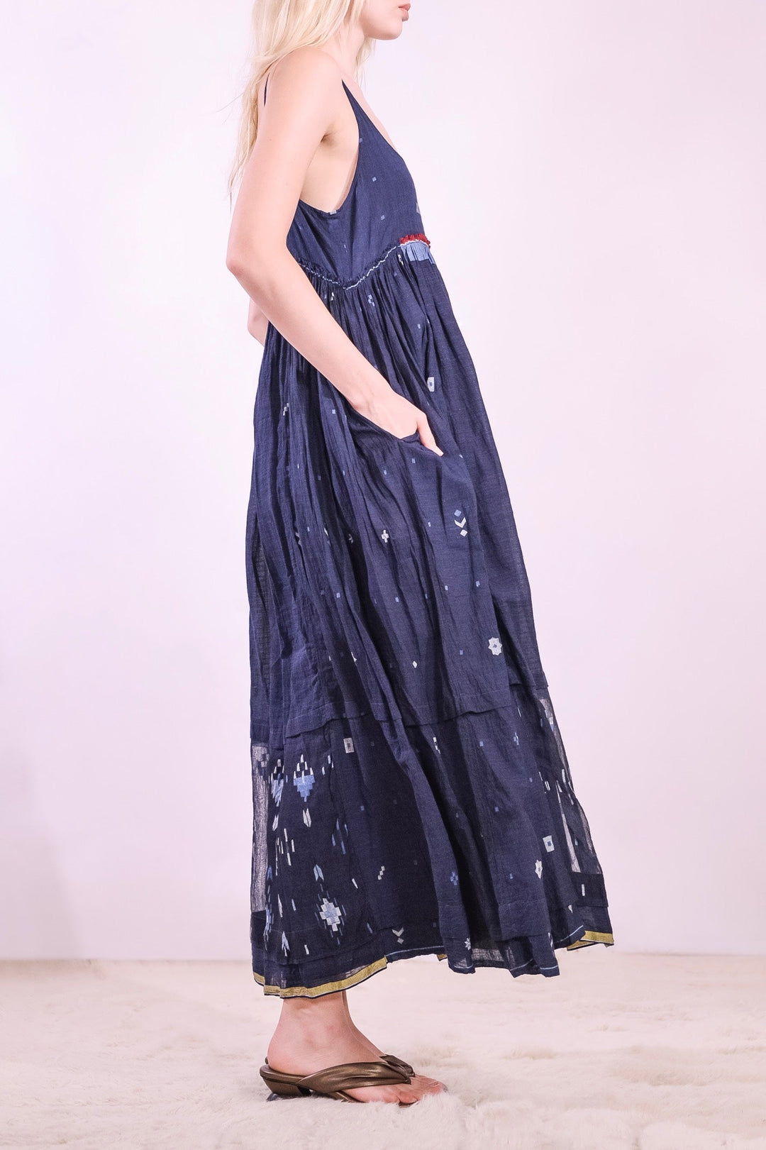 Model wearing the Amber 73 Slip Dress by Injiri in breathable organic cotton, with slim straps, a fitted bodice and a softly flared shape, curated by House of Nomad Stories.