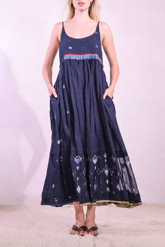 Model wearing the Amber 73 Slip Dress by Injiri, handmade in India from handwoven organic cotton naturally dyed in deep indigo, curated by House of Nomad Stories.