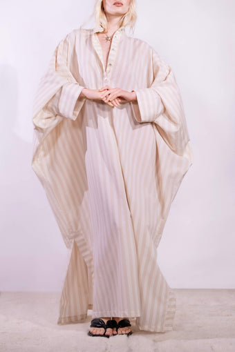 Model wearing the Fez striped shirt dress with batwing sleeves and button placket, handcrafted in Italy from 100% cotton by House of Woven Stories.