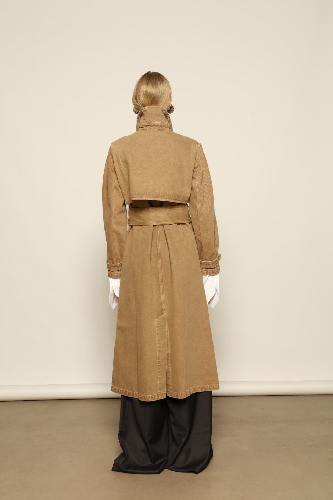 Back view of Le Trench Coat by HAPPY HAUS, highlighting its clean construction and softly flared silhouette.
