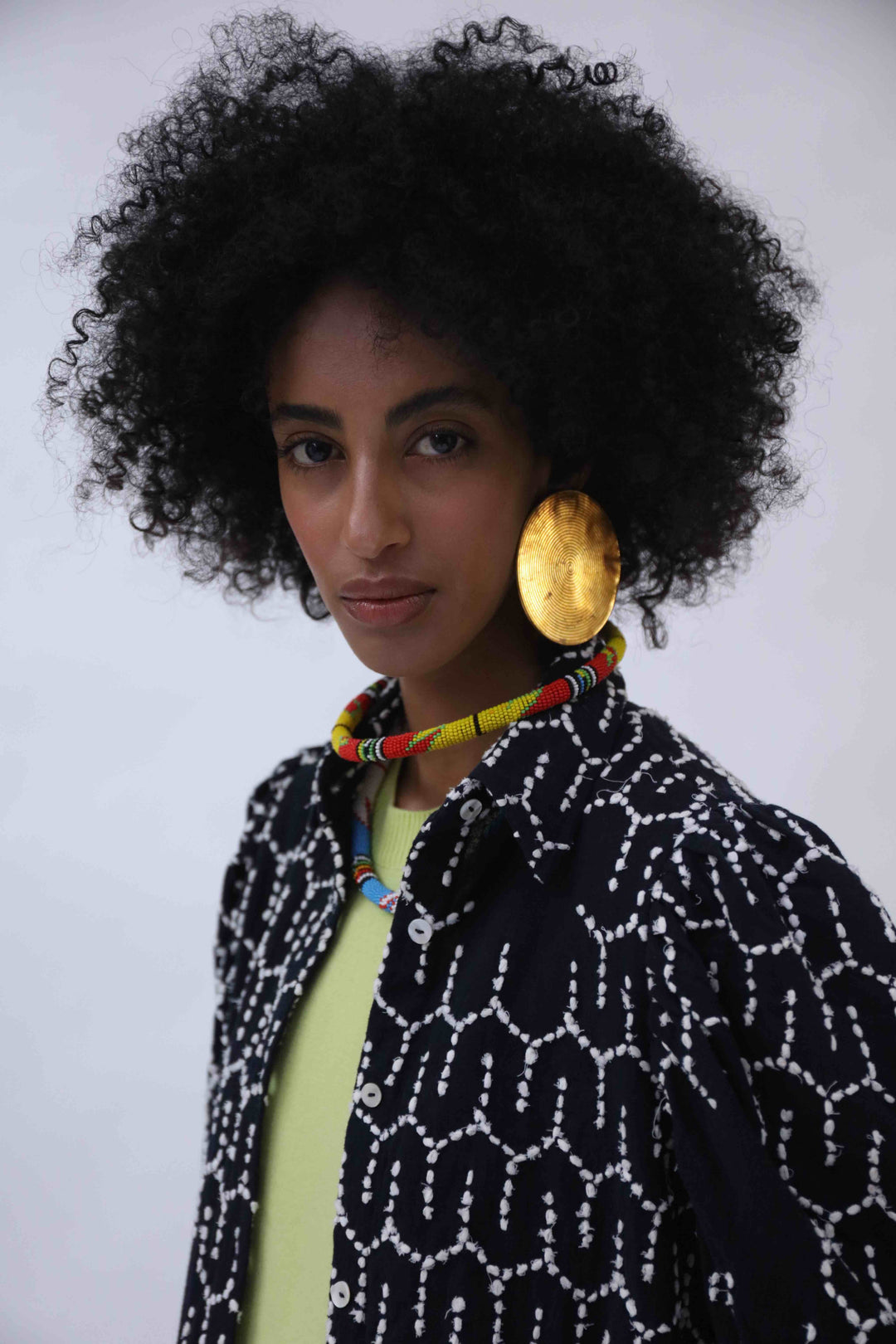 Structured puff-sleeve blouse with sharp collars and Paiwand’s signature upcycled embroidery on organic indigo-dyed cotton, handcrafted in India combining traditional craftsmanship with sustainable, modern fashion.
