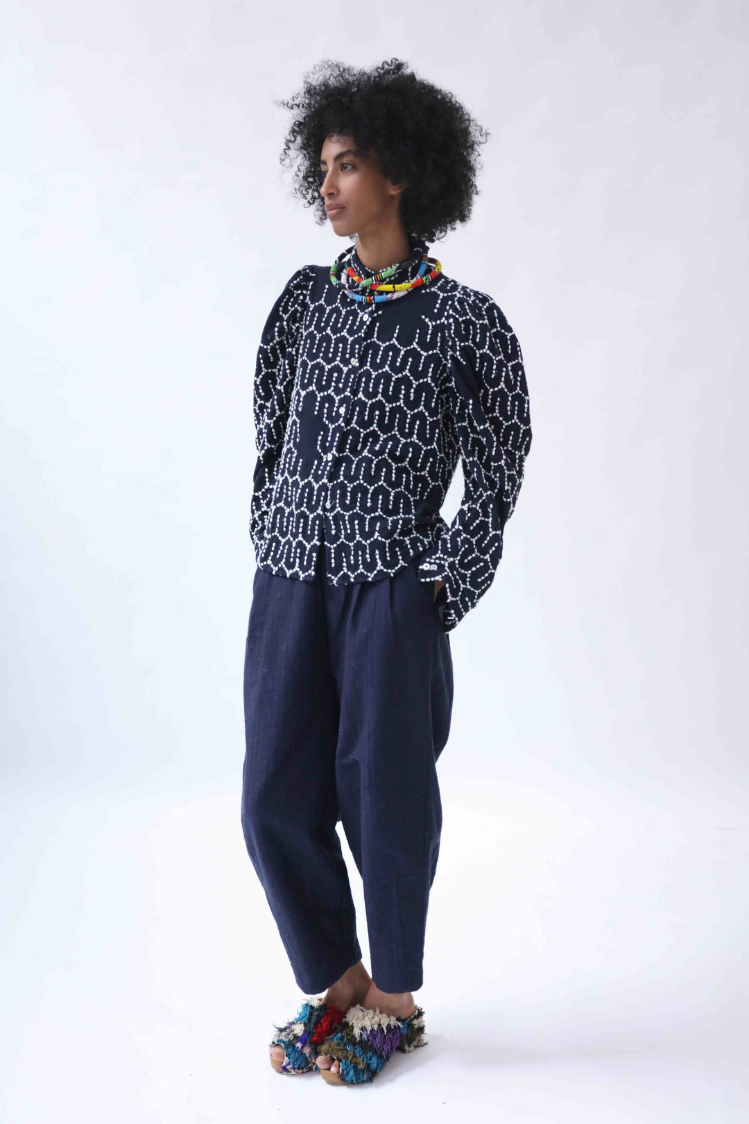 Structured puff-sleeve blouse with sharp collars and Paiwand’s signature upcycled embroidery on organic indigo-dyed cotton, handcrafted in India combining traditional craftsmanship with sustainable, modern fashion.