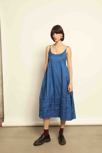 Model wearing the Folklore 102 Slip Dress by Injiri, handcrafted from 100% silk in deep blue with small white polka dots, curated by House of Nomad Stories.