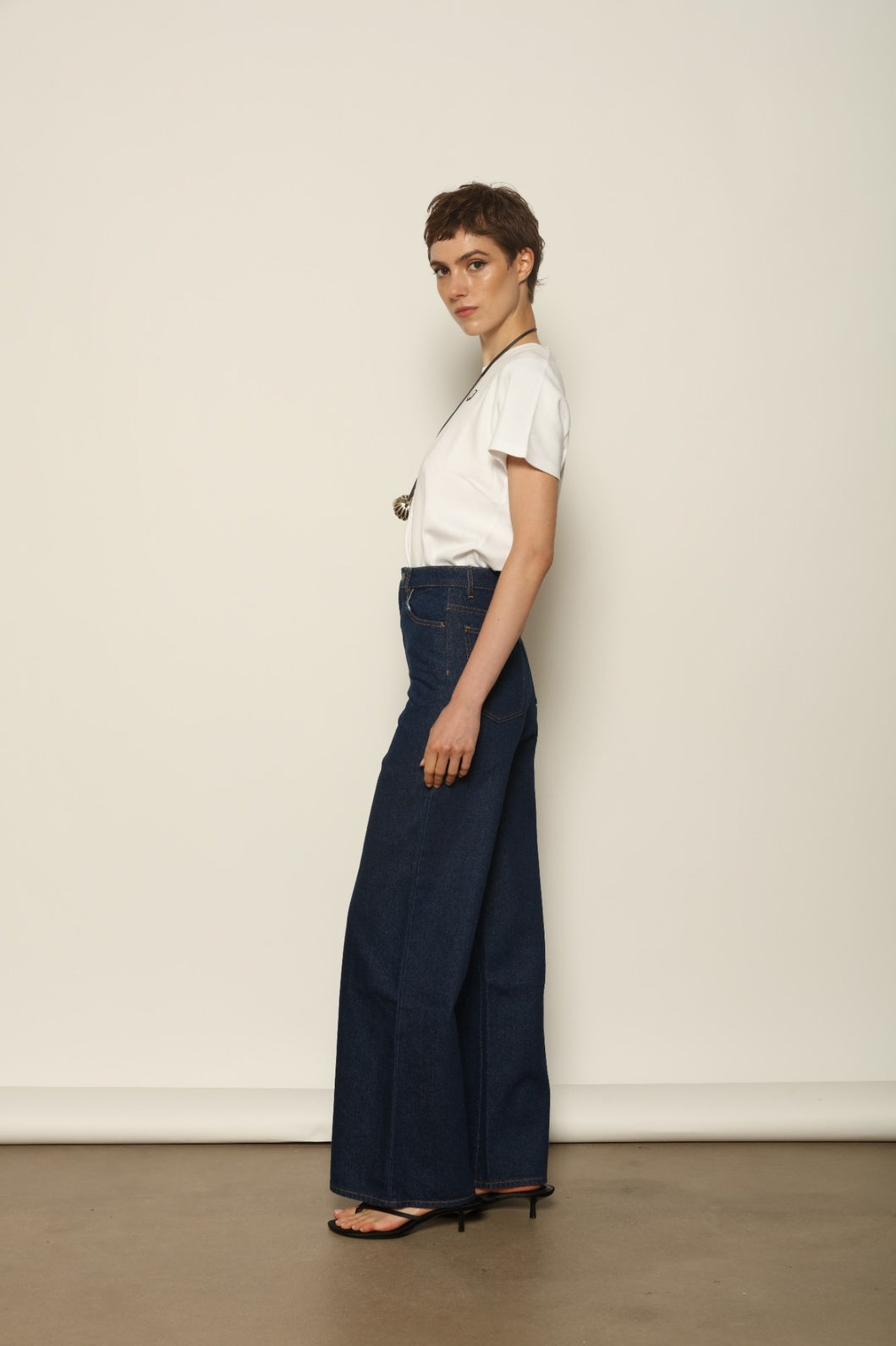 Side view of Le Pantalon Peacock by HAPPY HAUS, revealing its relaxed wide leg and clean straight cut.