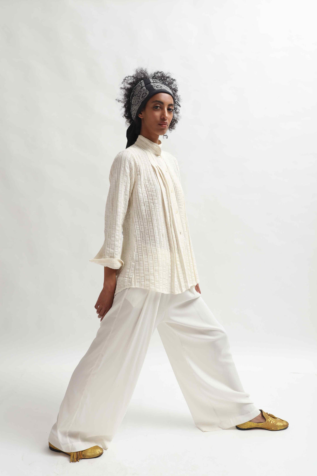 Leno Pleated Shirt by Paiwand made from upcycled cotton with breathable leno weave, featuring elegant pleats and handcrafted in India. Sustainable fashion curated by House of Nomad Stories.