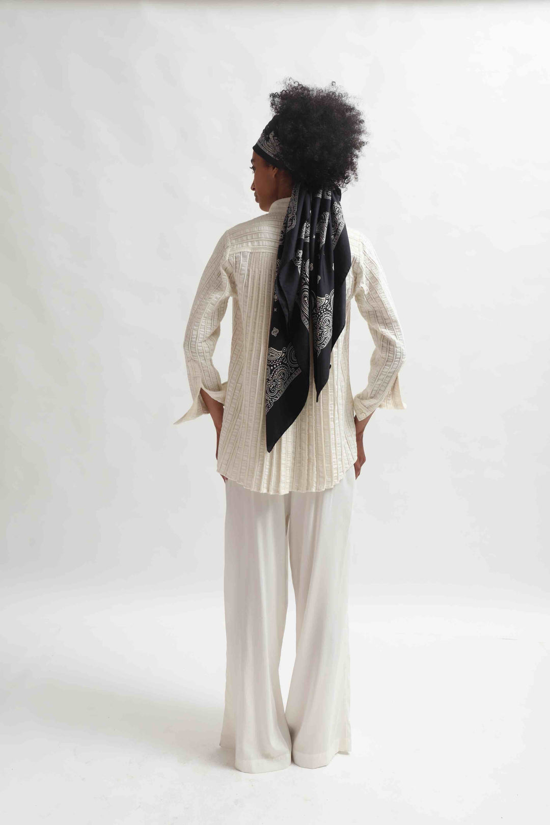 Leno Pleated Shirt by Paiwand made from upcycled cotton with breathable leno weave, featuring elegant pleats and handcrafted in India. Sustainable fashion curated by House of Nomad Stories.