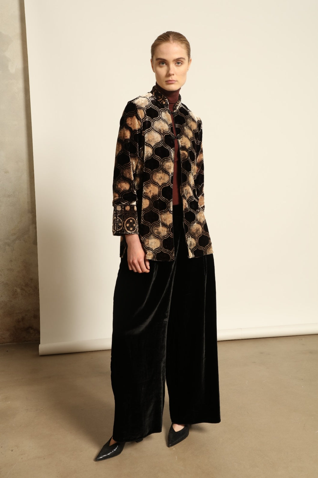 Model is wearing The Obsidian Cleo Jacket by Obidi, crafted from luxurious velvet with a structured yet fluid silhouette, blending contemporary design with traditional craftsmanship.