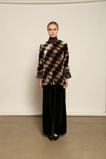 Model is wearing The Obsidian Cleo Jacket by Obidi, crafted from luxurious velvet with a structured yet fluid silhouette, blending contemporary design with traditional craftsmanship.
