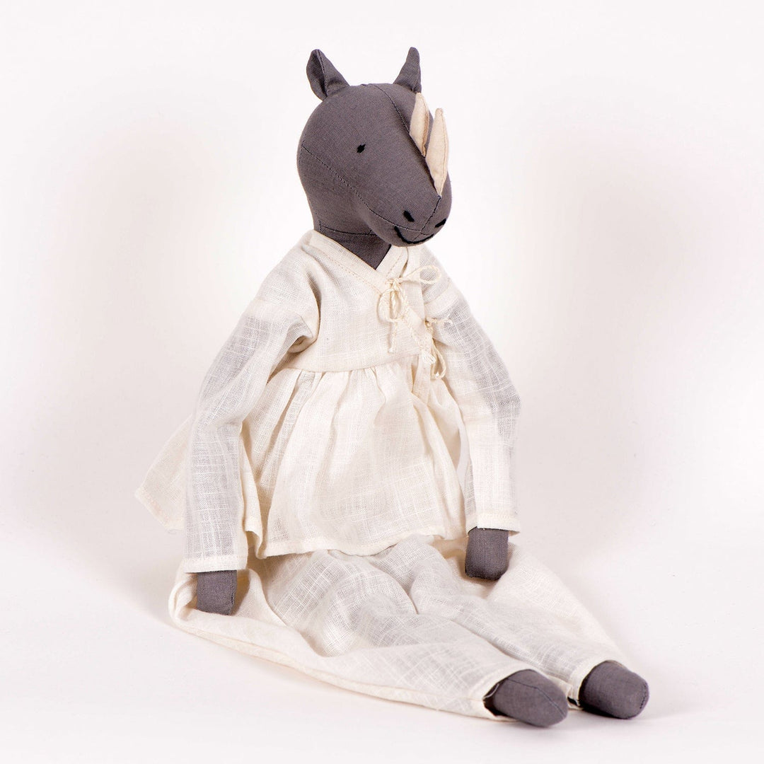Ura handcrafted rhinoceros cloth doll made from upcycled fabric by SilaiWali, with bedding in foldable box. Available at House of Nomad Stories.