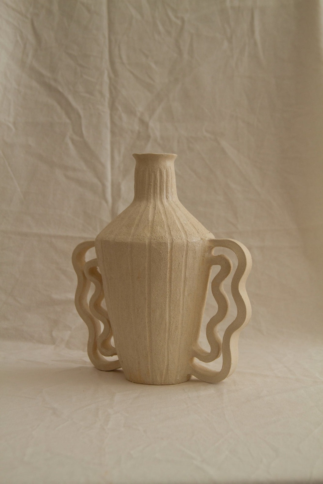 Amphora Le Grand Double Vagues by Clandestine Céramique, part of the House of Nomad Stories selection, handbuilt in chamotte clay with wavy double handles and engraved vertical stripes.