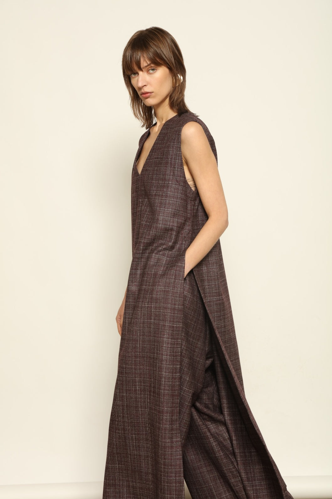 Model is wearing the Athen Burgundy Tunic Dress by House of Woven Stories, made from a wool, silk, and cashmere blend with longline silhouette and deep V-neck.