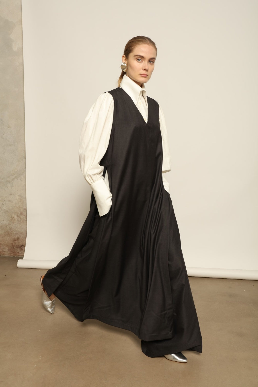 Model is wearing the Athen Twill Tunic Dress by House of Nomad Stories, styled as an elongated layered piece with a relaxed silhouette and open sides.