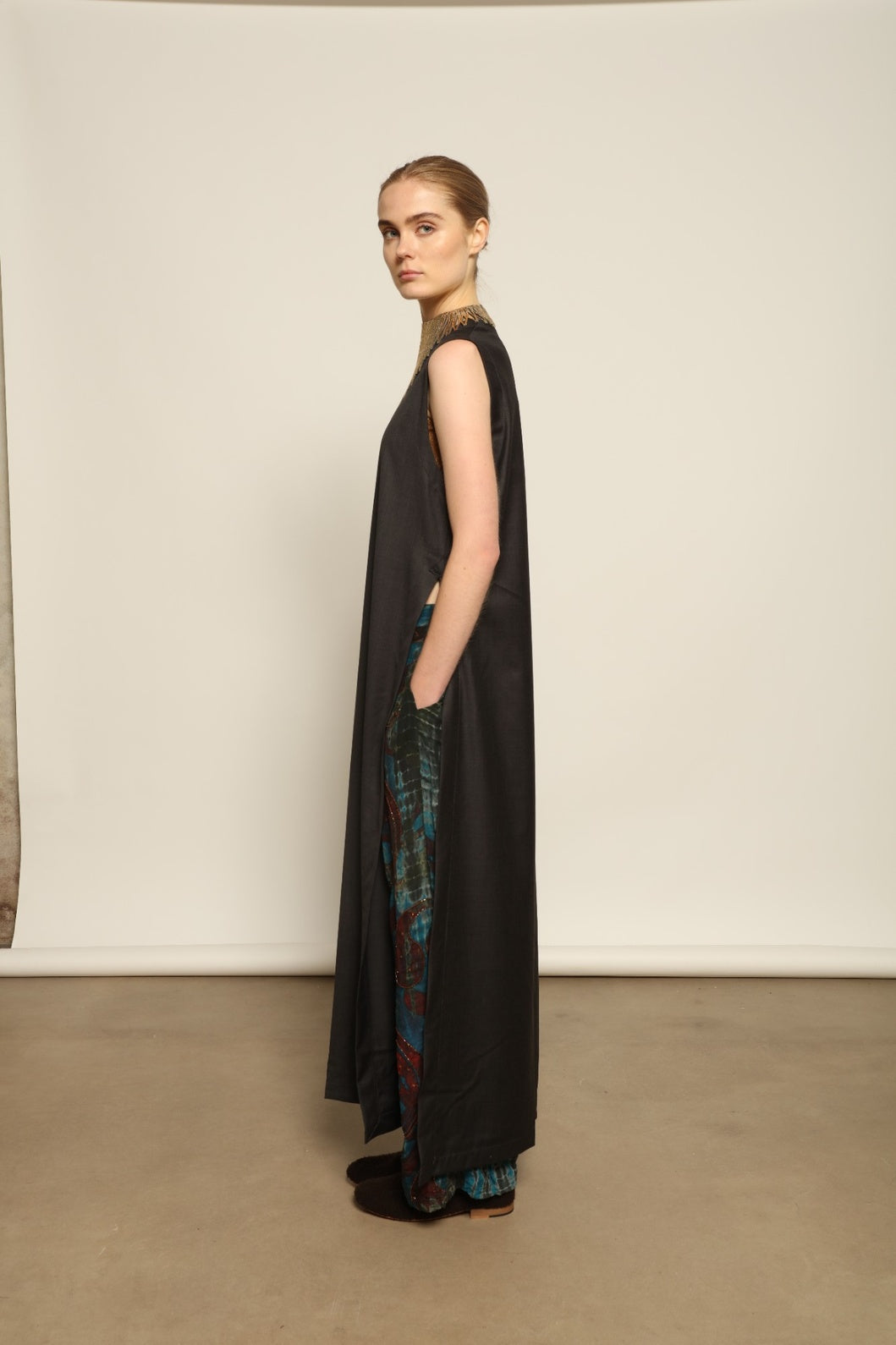 Model is wearing the Athen Twill Tunic Dress by House of Nomad Stories, styled as an elongated layered piece with a relaxed silhouette and open sides.