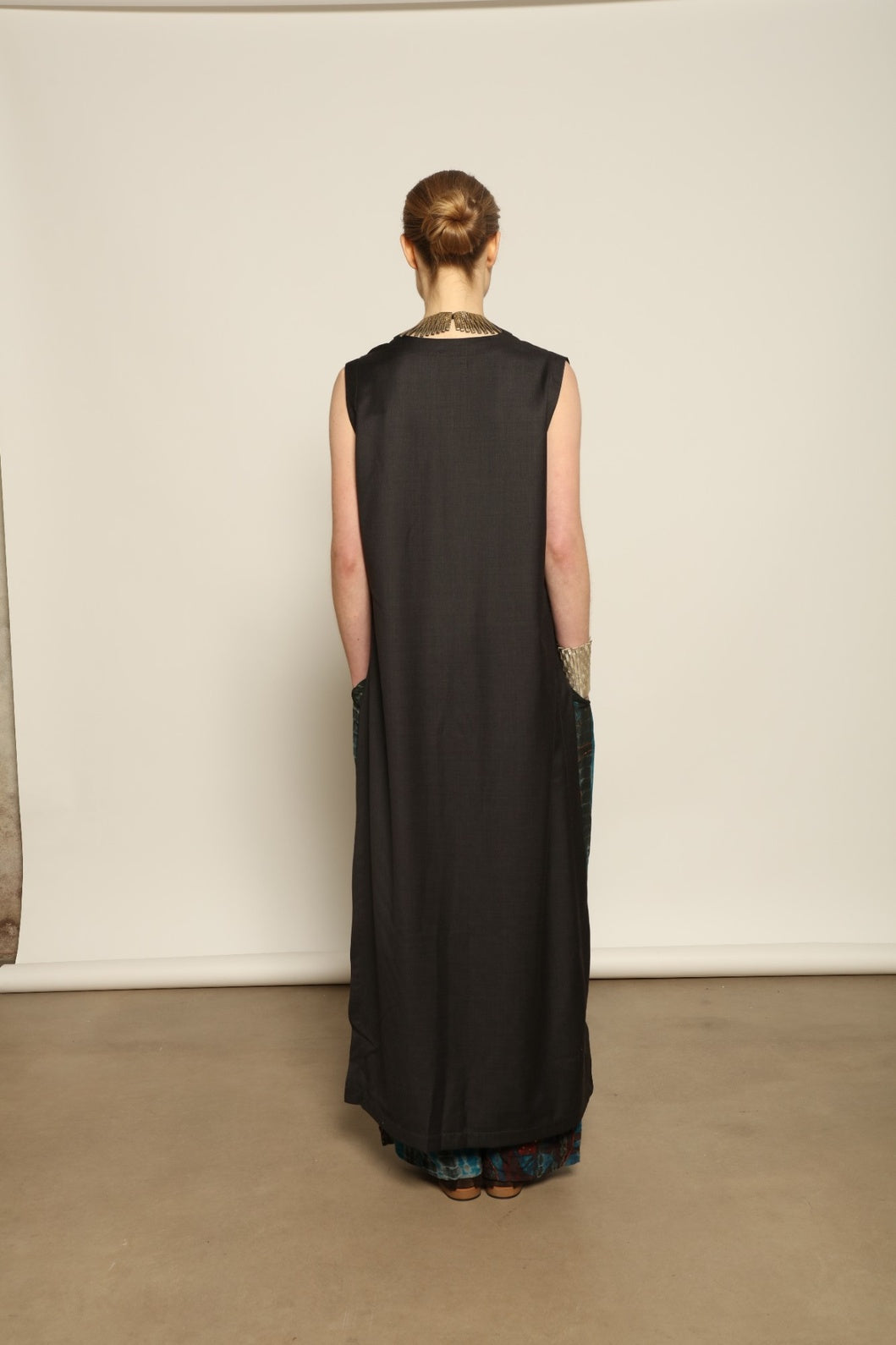 Model is wearing the Athen Twill Tunic Dress by House of Nomad Stories, styled as an elongated layered piece with a relaxed silhouette and open sides.