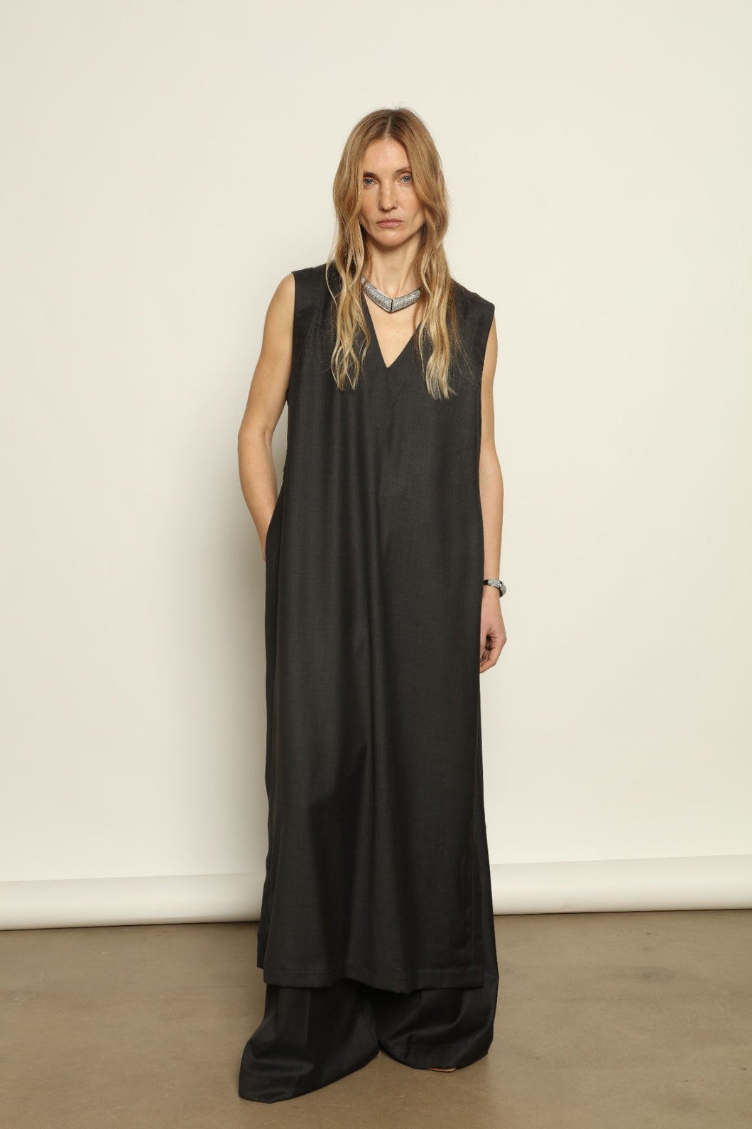 Model is wearing the Athen Twill Tunic Dress by House of Nomad Stories, styled as an elongated layered piece with a relaxed silhouette and open sides.