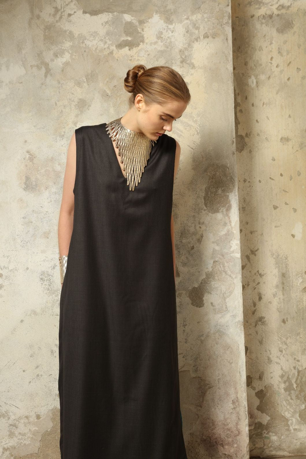 Model is wearing the Athen Twill Tunic Dress by House of Nomad Stories, styled as an elongated layered piece with a relaxed silhouette and open sides.