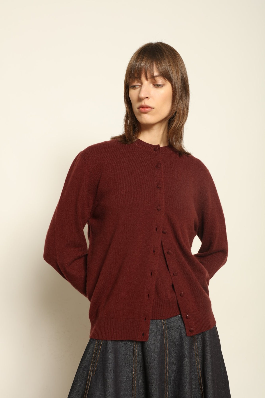 Model wearing the Burgundy Nathalie Cashmere Cardigan by House of Nomad Stories, made from 100% pure Inner Mongolia cashmere, featuring a deep burgundy shade, open-front design, relaxed silhouette, flowing drape, and sustainable luxury craftsmanship