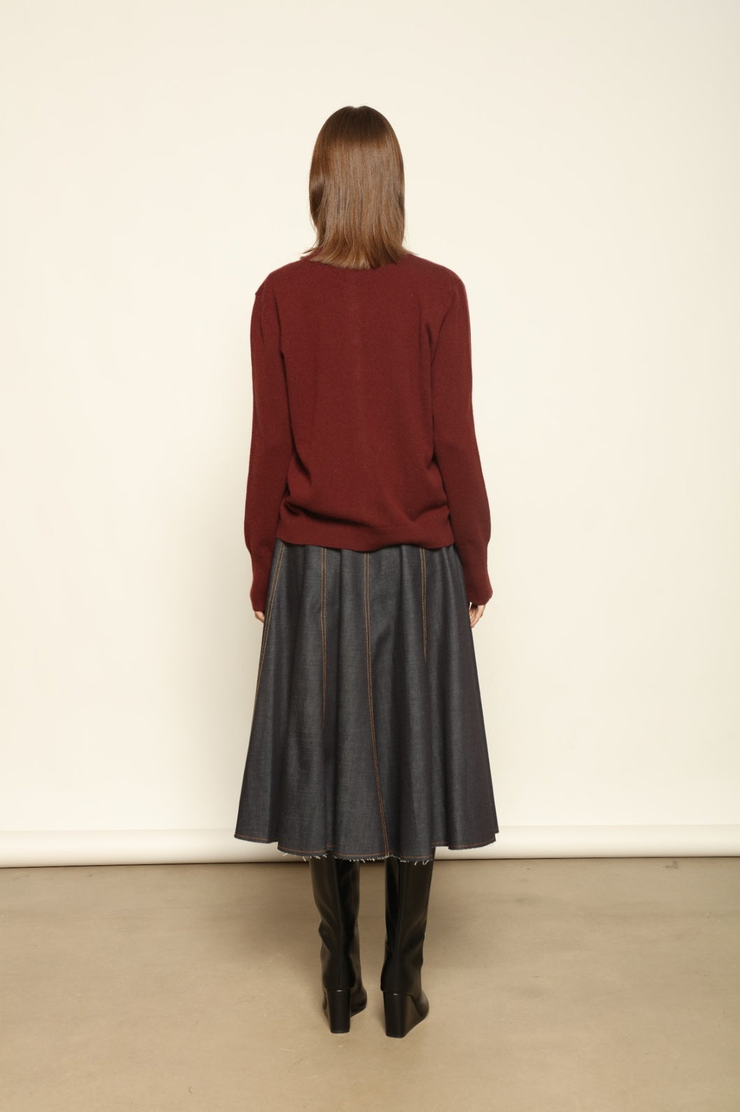 Model wearing the Burgundy Nathalie Cashmere Cardigan by House of Nomad Stories, made from 100% pure Inner Mongolia cashmere, featuring a deep burgundy shade, open-front design, relaxed silhouette, flowing drape, and sustainable luxury craftsmanship