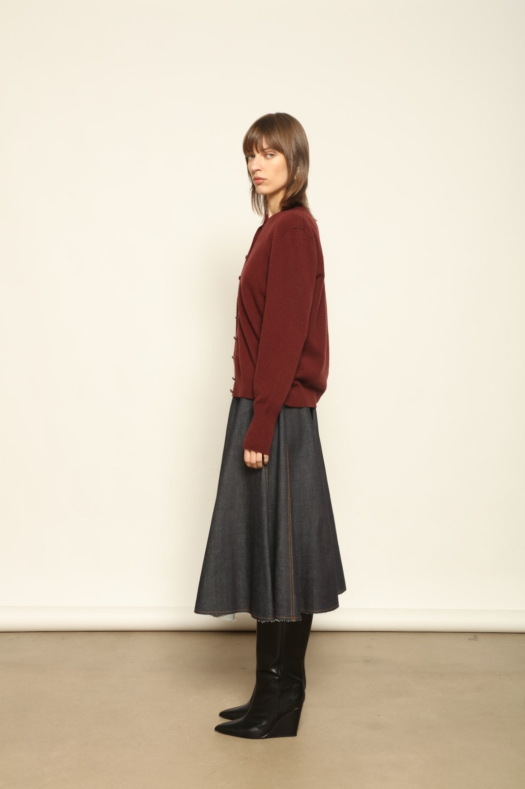 Model wearing the Burgundy Nathalie Cashmere Cardigan by House of Nomad Stories, made from 100% pure Inner Mongolia cashmere, featuring a deep burgundy shade, open-front design, relaxed silhouette, flowing drape, and sustainable luxury craftsmanship