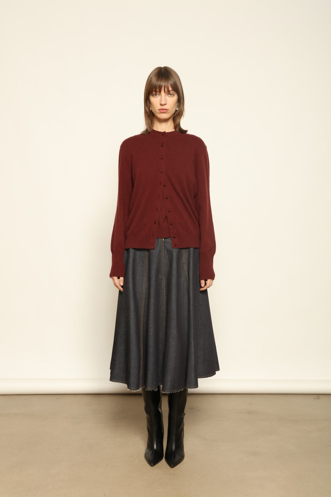 Model wearing the Burgundy Nathalie Cashmere Cardigan by House of Nomad Stories, made from 100% pure Inner Mongolia cashmere, featuring a deep burgundy shade, open-front design, relaxed silhouette, flowing drape, and sustainable luxury craftsmanship