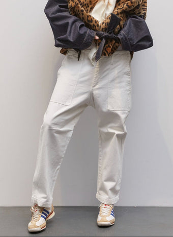 Model wearing the Camille White Cotton Pant by Maison Jejia, featuring relaxed silhouette, oversized patch pockets, breathable cotton fabric, and fluid leg shape for modern everyday elegance
