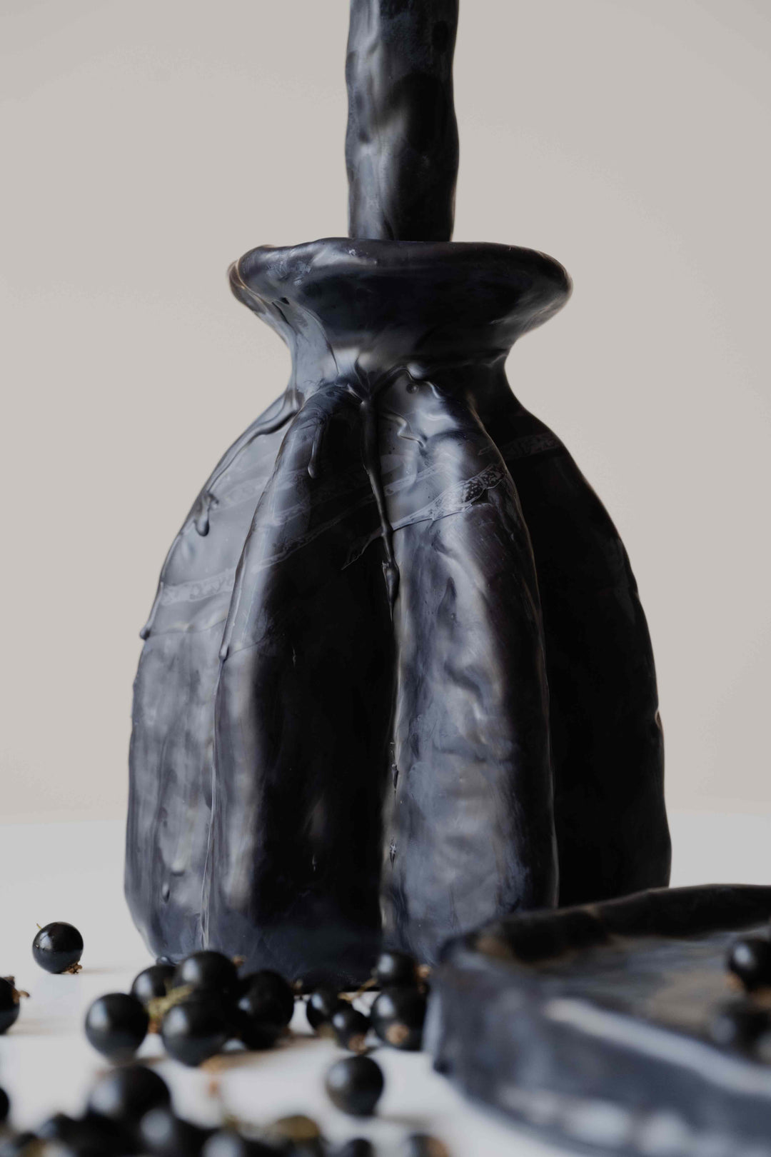 Carambola High in Black by Oberflacht, handcrafted beeswax candle holder with matching twig candle and sculptural matte finish. 