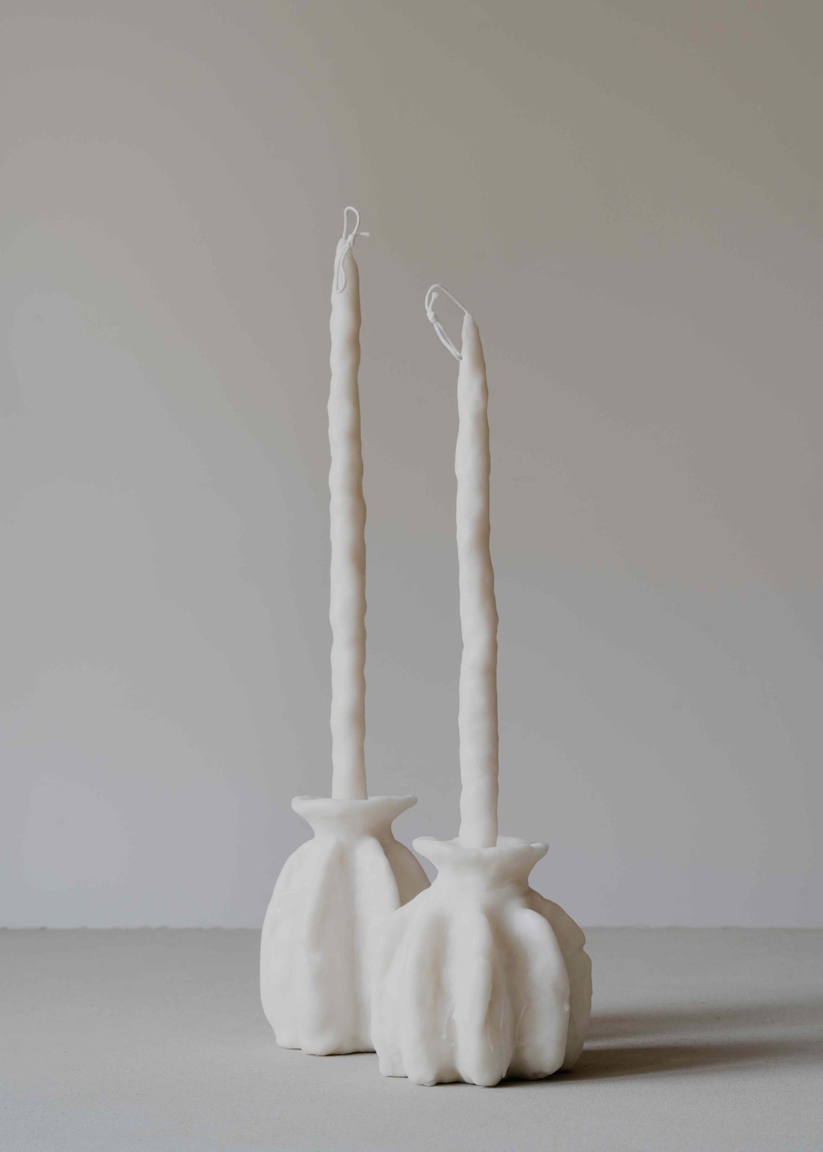 Carambola Low in Cream candle holder by Oberflacht, part of the House of Nomad Stories selection, handcrafted from beeswax and paraffin with matching twig candle and subtle variations in colour, shape, and texture.