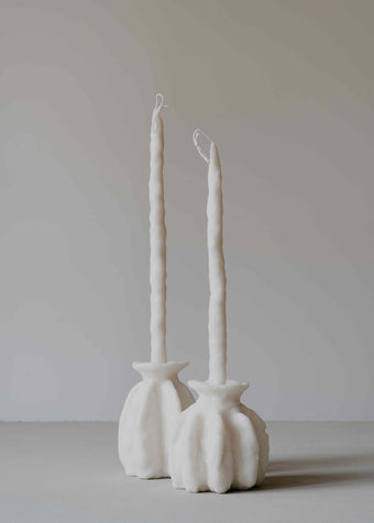 Carambola Low in Cream candle holder by Oberflacht, part of the House of Nomad Stories selection, handcrafted from beeswax and paraffin with matching twig candle and subtle variations in colour, shape, and texture.