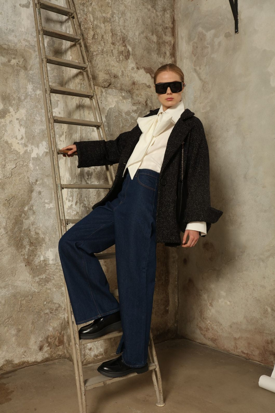 Model is wearing the Carla Maxi Chevron Blazer by House of Woven Stories, crafted from premium Merino wool with chevron weave and an oversized silhouette, combining timeless refinement with modern tailoring.