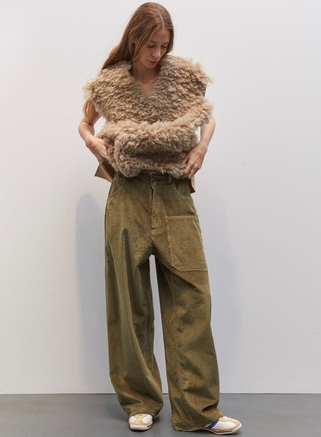 Model wearing the Carla Military Green Velvet Pant by Maison Jejia, part of the House of Nomad Stories selection, featuring plush velvet, relaxed tailored silhouette, and deep military green tone
