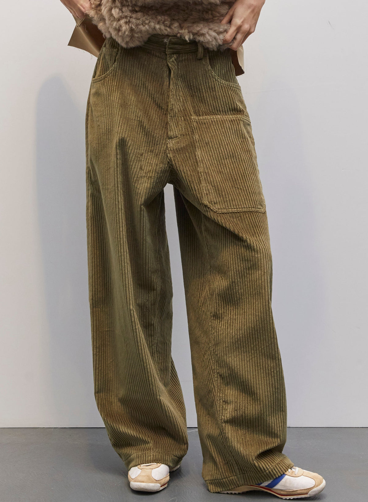 Model wearing the Carla Military Green Velvet Pant by Maison Jejia, part of the House of Nomad Stories selection, featuring plush velvet, relaxed tailored silhouette, and deep military green tone
