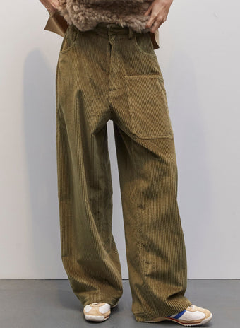 Model wearing the Carla Military Green Velvet Pant by Maison Jejia, part of the House of Nomad Stories selection, featuring plush velvet, relaxed tailored silhouette, and deep military green tone