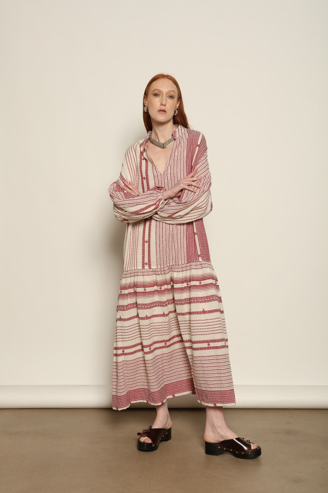 Model is wearing the Cherry Red Chemena Dress by House of Woven Stories, a relaxed 100% organic handspun Kahla cotton dress crafted in Gujarat, India, with a fluid silhouette and effortless, feminine character.