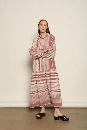 Model is wearing the Cherry Red Chemena Dress by House of Woven Stories, a relaxed 100% organic handspun Kahla cotton dress crafted in Gujarat, India, with a fluid silhouette and effortless, feminine character.