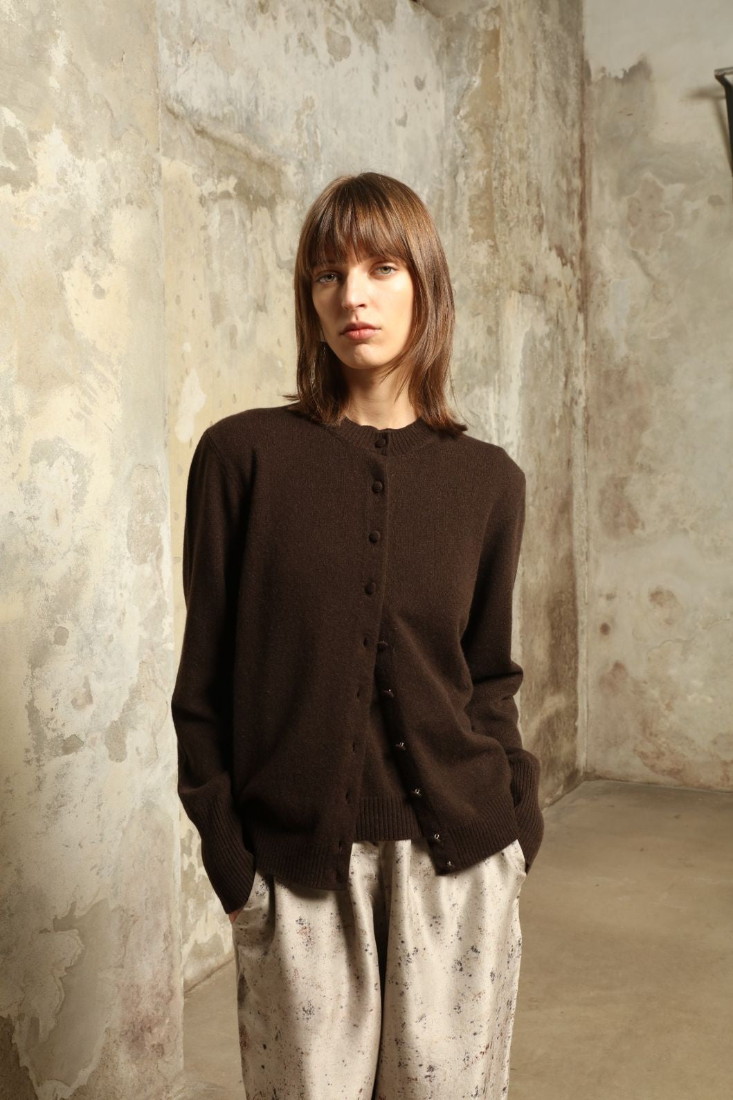 Model wearing the Chocolate Nathalie Open-Front Cashmere Cardigan by House of Nomad Stories, crafted from 100% Inner Mongolia cashmere, featuring a relaxed silhouette, smooth texture, and sustainable luxury knitwear in rich chocolate tone