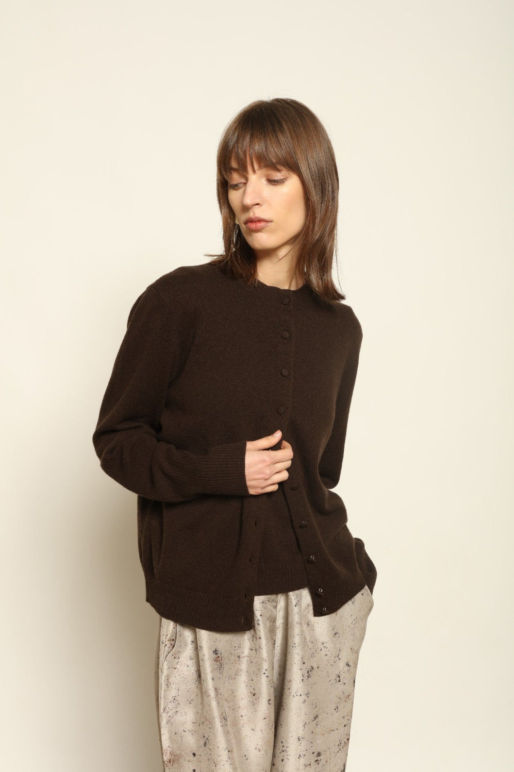 Model wearing the Chocolate Nathalie Open-Front Cashmere Cardigan by House of Nomad Stories, crafted from 100% Inner Mongolia cashmere, featuring a relaxed silhouette, smooth texture, and sustainable luxury knitwear in rich chocolate tone