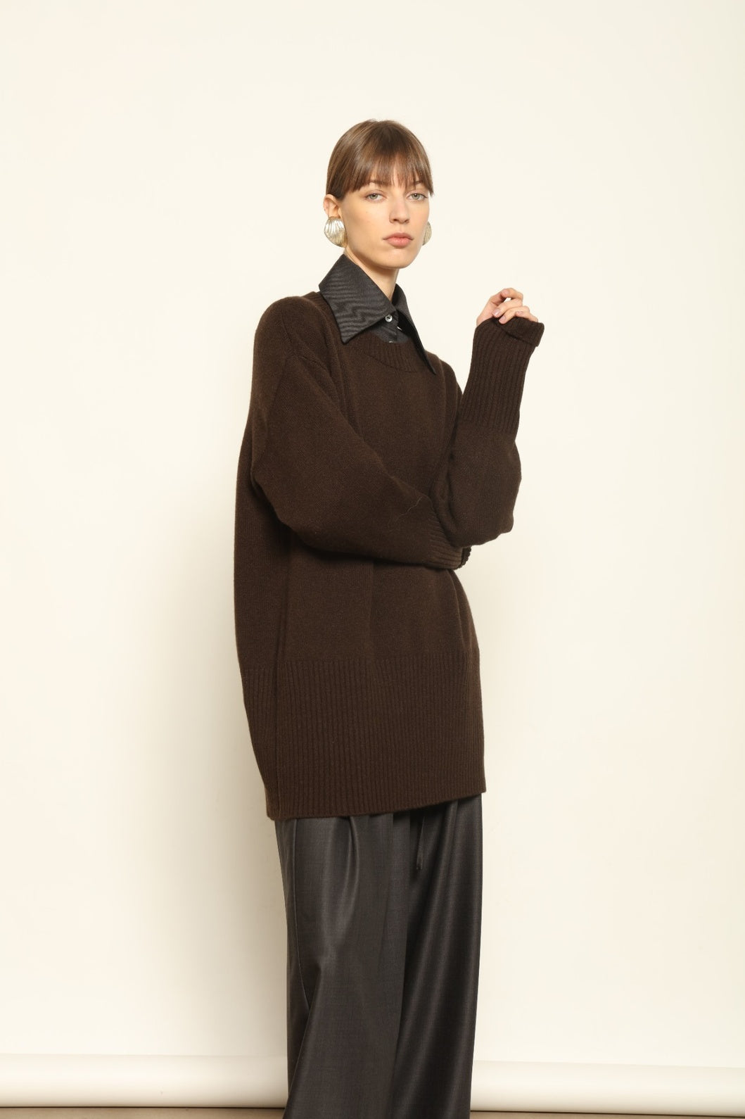 Model wearing the Chocolate Noemi Round Neck Cashmere Pullover by House of Nomad Stories, made from 100% pure Inner Mongolia cashmere, featuring a deep chocolate tone, soft texture, relaxed fit, and sustainable luxury craftsmanship