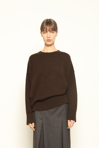 Model is wearing the chocolate Noemi Round Neck Pullover by House of Nomad Stories, made from 100% pure Inner Mongolia cashmere, featuring ultra-soft, breathable, durable knitwear, relaxed fit, and timeless luxury craftsmanship
