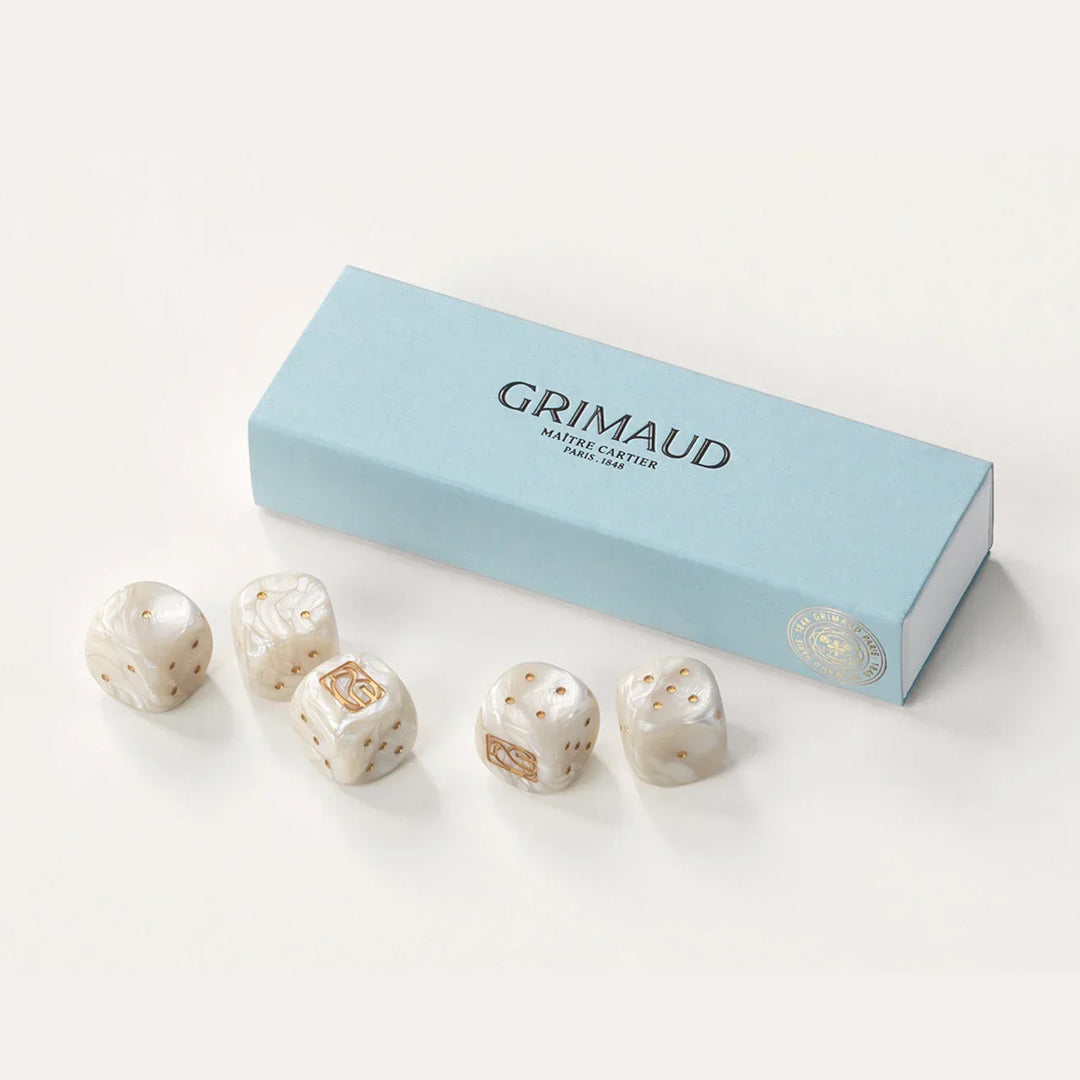 Coffret de dés Grimaud Paris from the House of Nomad Stories selection, luxury 5 dice set made in France, white resin dice with gold pips in a Dolphin Blue case.