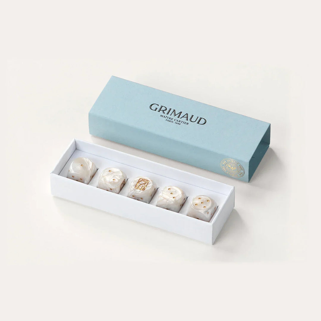 Coffret de dés Grimaud Paris from the House of Nomad Stories selection, luxury 5 dice set made in France, white resin dice with gold pips in a Dolphin Blue case.