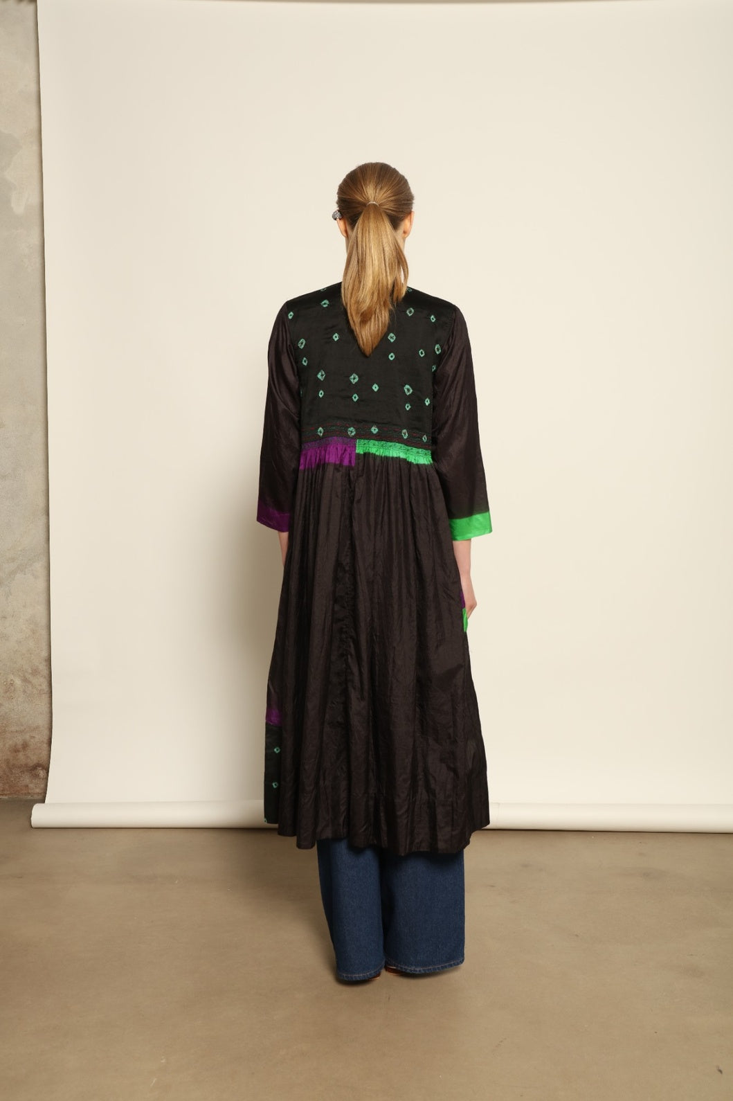 Model is wearing Folklore 10 Handmade Cotton and Silk Dress by Injiri, part of the House of Nomad Stories selection, crafted in India from a cotton and silk blend with round neckline, long sleeves, side pockets, and artisanal detailing.