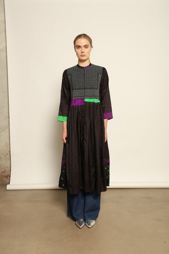 Model is wearing Folklore 10 Handmade Cotton and Silk Dress by Injiri, part of the House of Nomad Stories selection, crafted in India from a cotton and silk blend with round neckline, long sleeves, side pockets, and artisanal detailing.
