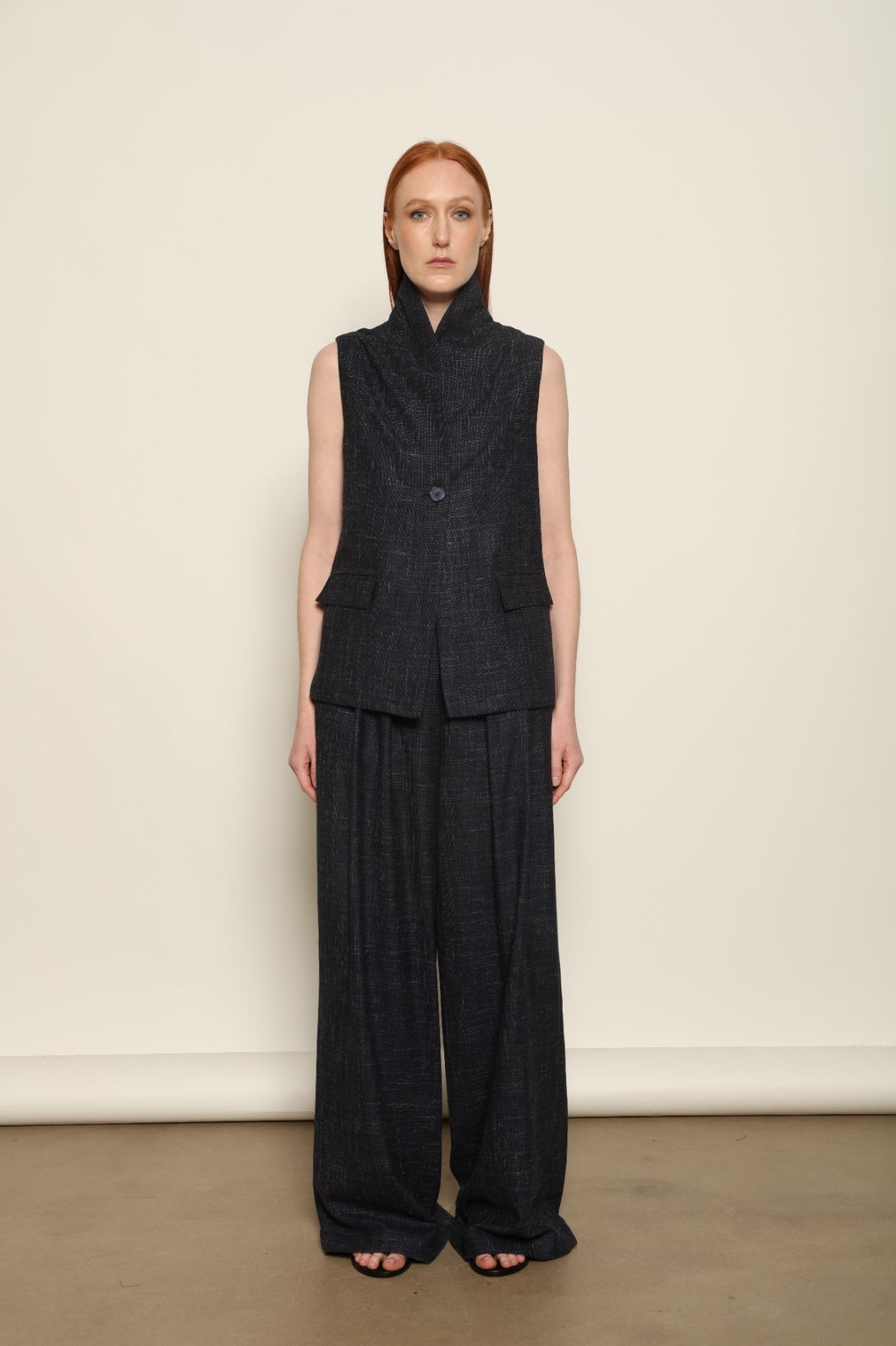 Model is wearing the Franca night blue and white gilet from the House of Woven Stories selection, a women’s tailored waistcoat made in Italy in Piedmont with a softly structured silhouette, designed for fluid layering and ethical contemporary fashion.