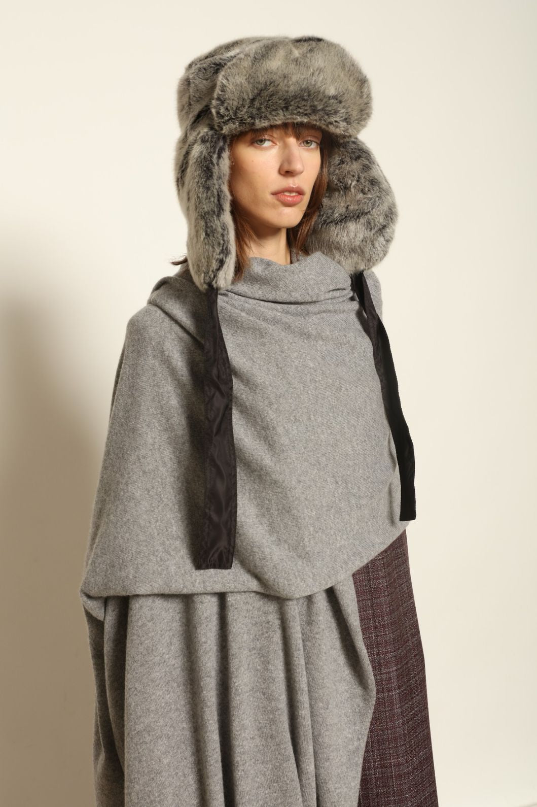 Model wearing the Graphite Leni Cashmere Scarf by House of Nomad Stories, made from 100% pure Inner Mongolia cashmere, featuring a soft graphite color, lightweight drape, smooth texture, lasting warmth, and sustainable luxury craftsmanship