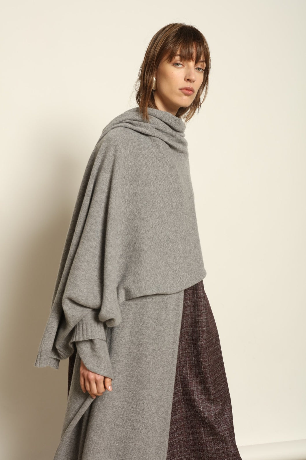 Model wearing the Graphite Leni Cashmere Scarf by House of Nomad Stories, made from 100% pure Inner Mongolia cashmere, featuring a soft graphite color, lightweight drape, smooth texture, lasting warmth, and sustainable luxury craftsmanship