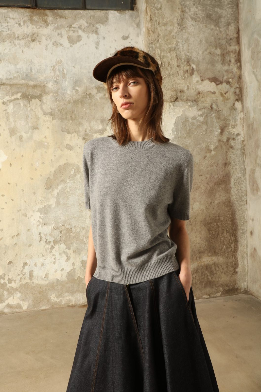 Model wearing the Graphite Natascha Round Neck Cashmere Pullover by House of Woven Stories, crafted from 100% pure Inner Mongolia cashmere, featuring a deep graphite grey tone, soft breathable texture, relaxed fit, and sustainable luxury craftsmanship