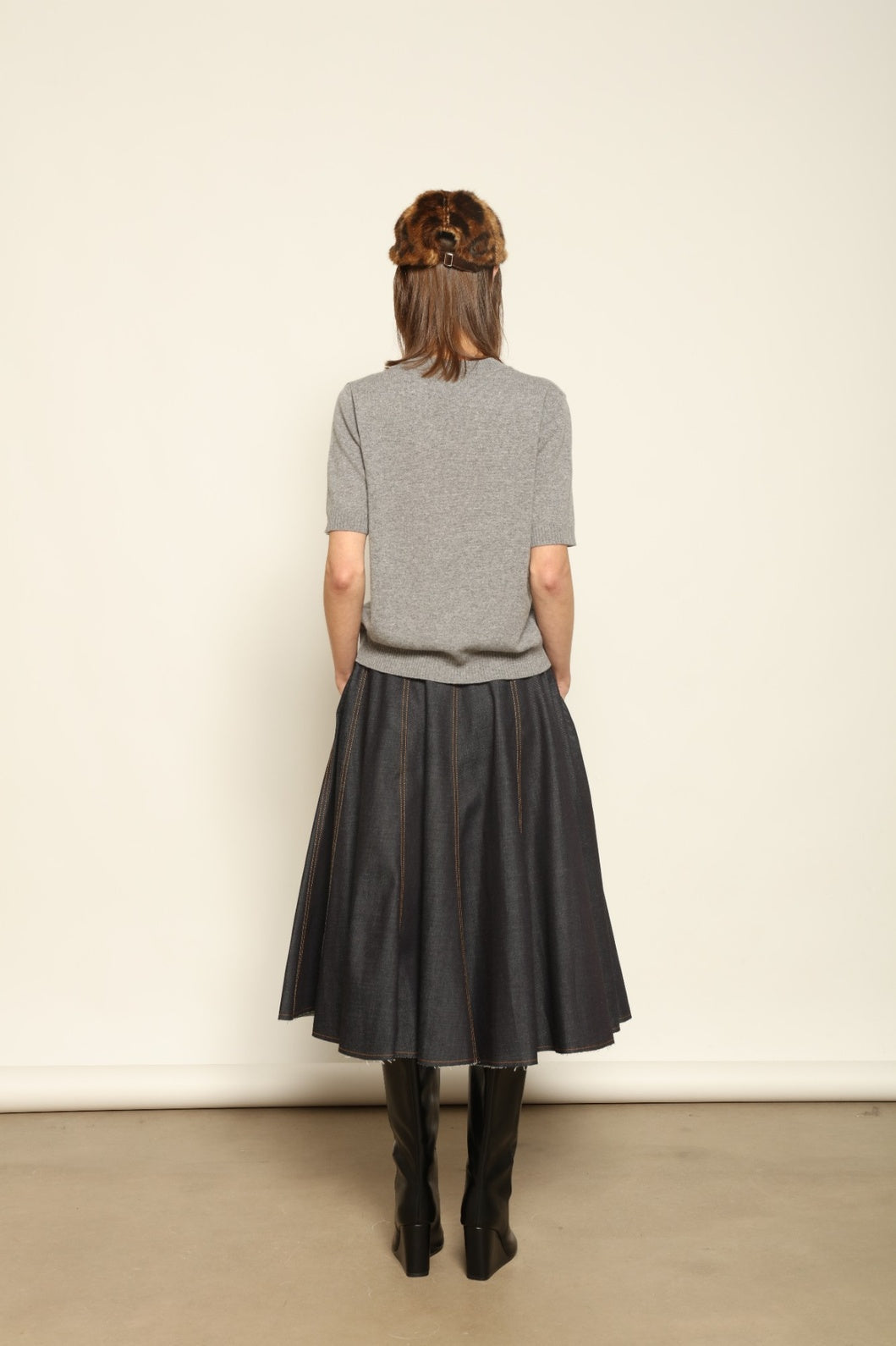 Model wearing the Graphite Natascha Round Neck Cashmere Pullover by House of Woven Stories, crafted from 100% pure Inner Mongolia cashmere, featuring a deep graphite grey tone, soft breathable texture, relaxed fit, and sustainable luxury craftsmanship