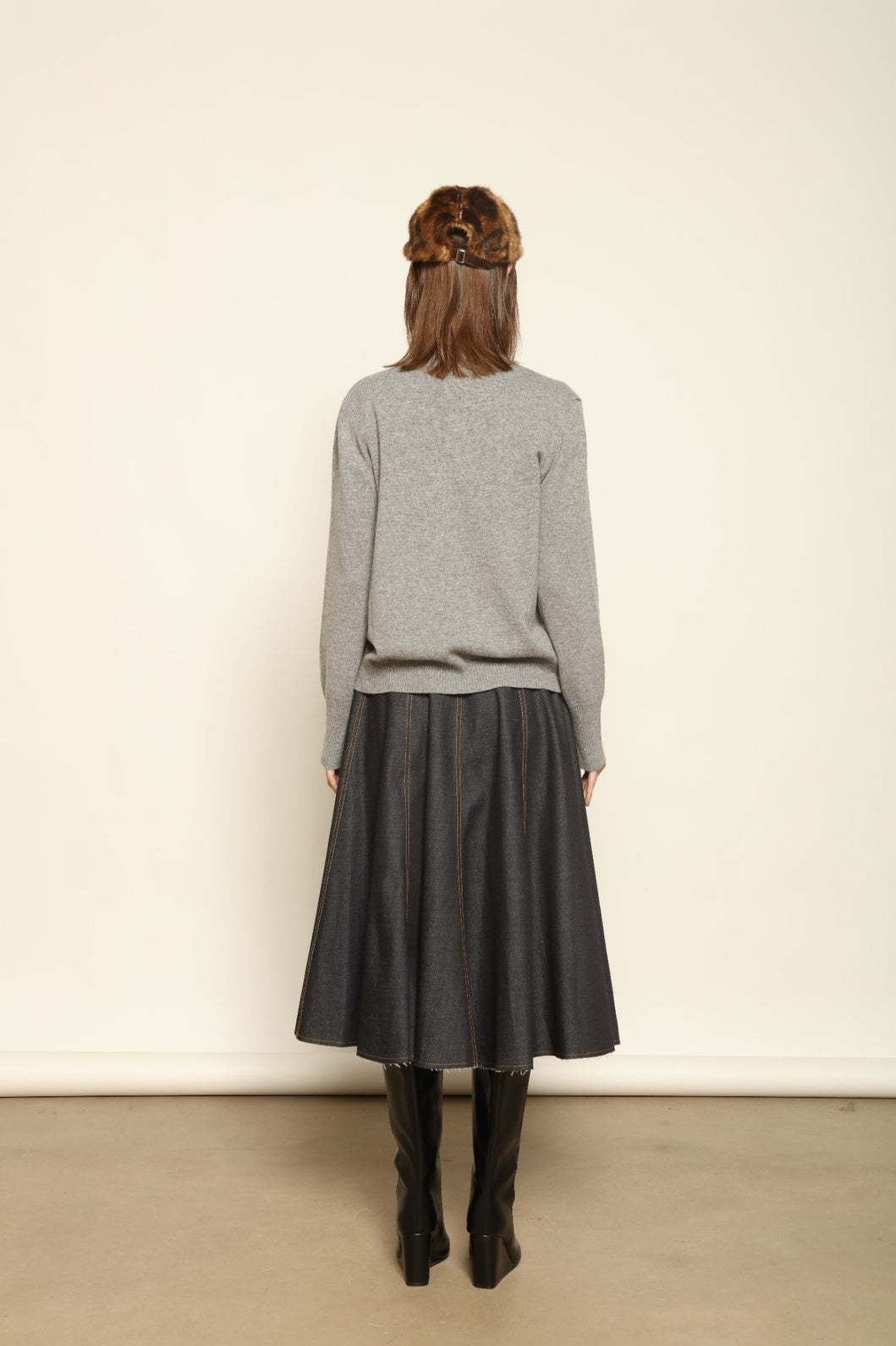 Model wearing the Graphite Nathalie Cashmere Cardigan by House of Nomad Stories, made from 100% pure Inner Mongolia cashmere, featuring a deep graphite grey tone, soft breathable texture, open-front silhouette, and sustainable luxury craftsmanship