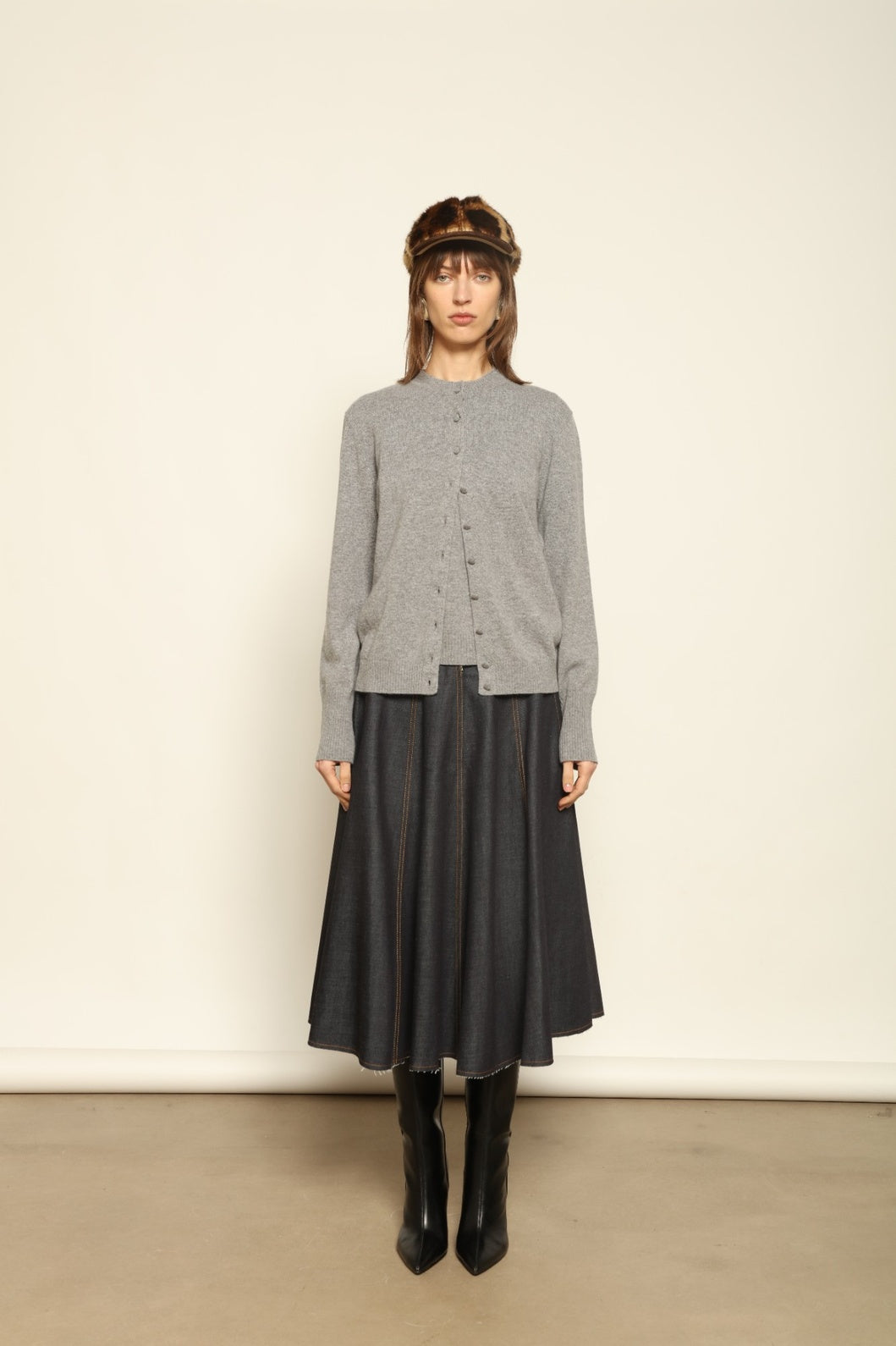 Model wearing the Graphite Nathalie Cashmere Cardigan by House of Nomad Stories, made from 100% pure Inner Mongolia cashmere, featuring a deep graphite grey tone, soft breathable texture, open-front silhouette, and sustainable luxury craftsmanship